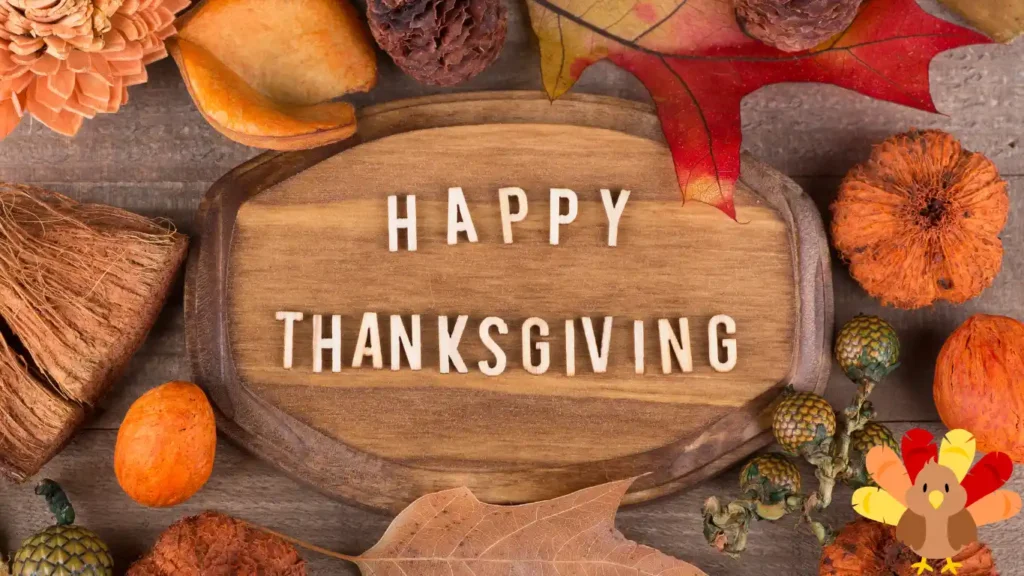 Wooden plaque with "Happy Thanksgiving" surrounded by autumn leaves, pinecones, and small pumpkins, offering a festive touch perfect for hosting Thanksgiving trivia questions and answers with family.